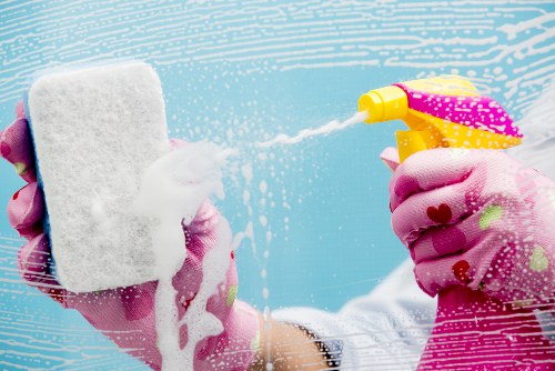 Team member following hygienic cleaning procedures in a room