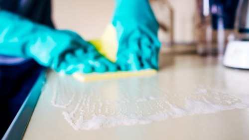 Technician treating mattress stains in a Collierswood bedroom